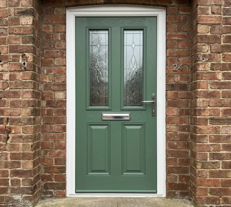 Green composite front door with decorative glass
