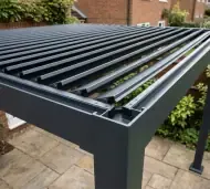 Aluminium pergola over a garden dining set