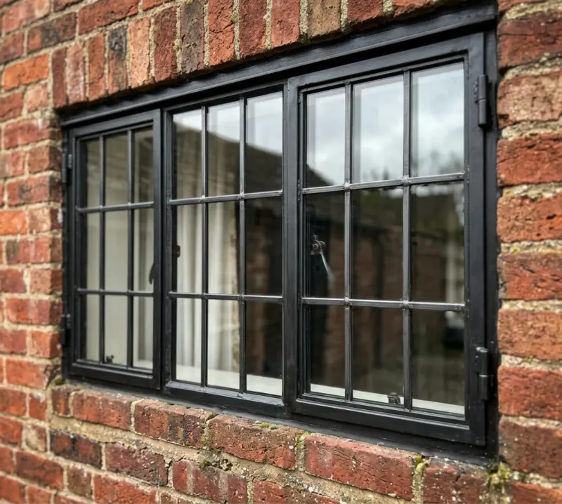 Slim black window grid on brick
