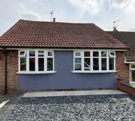 White uPVC bay windows on a rendered bungalow