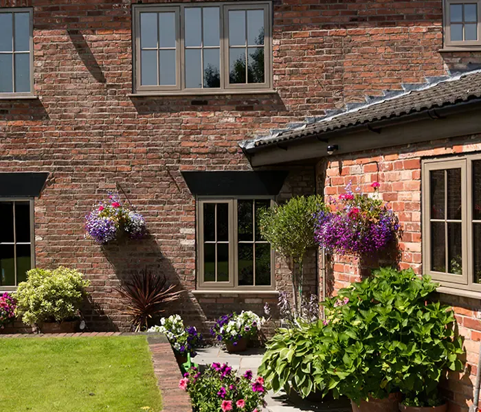 Brown Eurocell Modus flush-style windows on a red-brick home